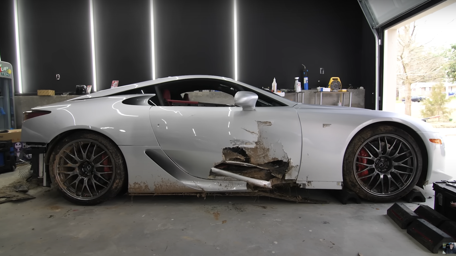 Crashed Lexus LFA showing damage to right-hand door